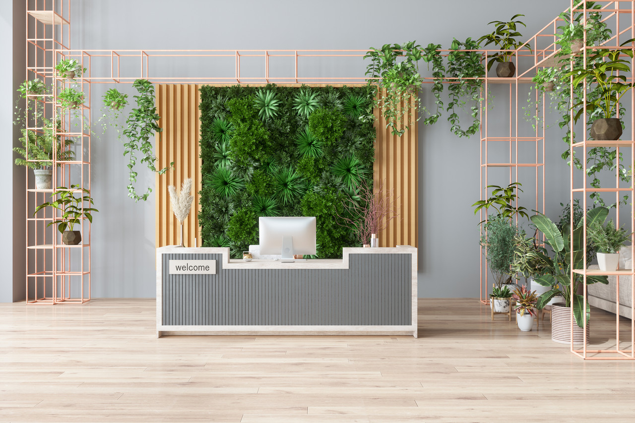 Eco-Friendly Office Or Hotel Lobby Interior With Reception Desk, Houseplants And Vertical Garden Background.